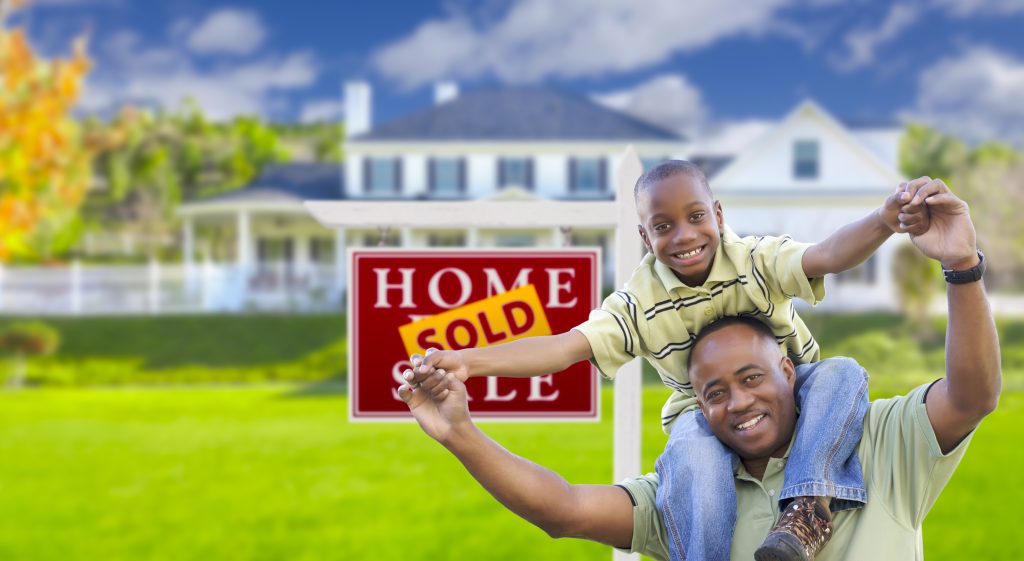 Father and Son in front of newly acquired home with Homeowner Renters Insurance