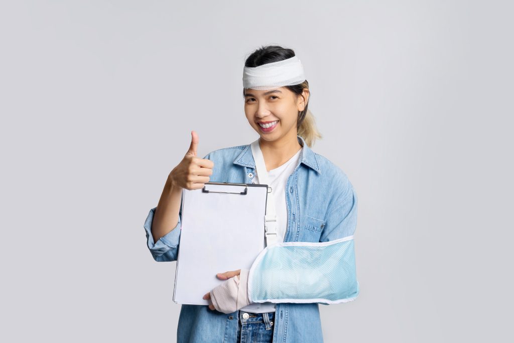 Treated Woman holding Workers Compensation Insurance policy papers.